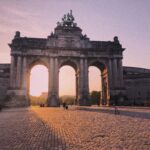 Bruxelles monument at sunset and a cobbled street