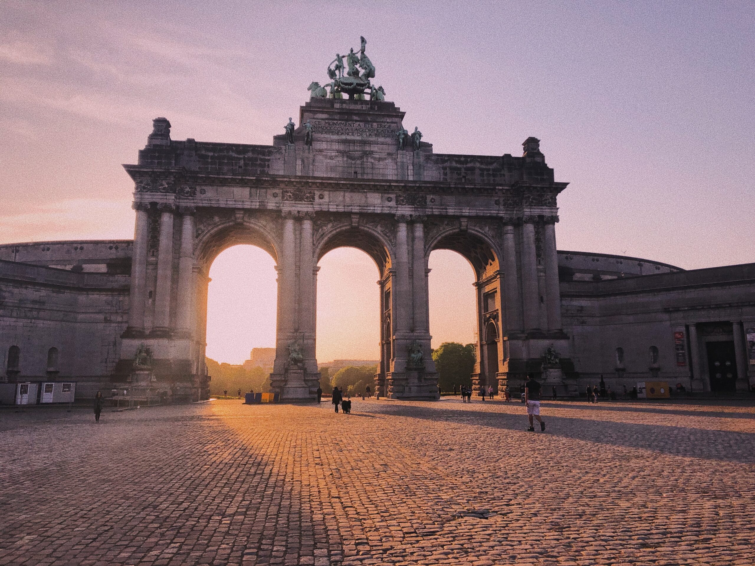 Bruxelles monument at sunset and a cobbled street