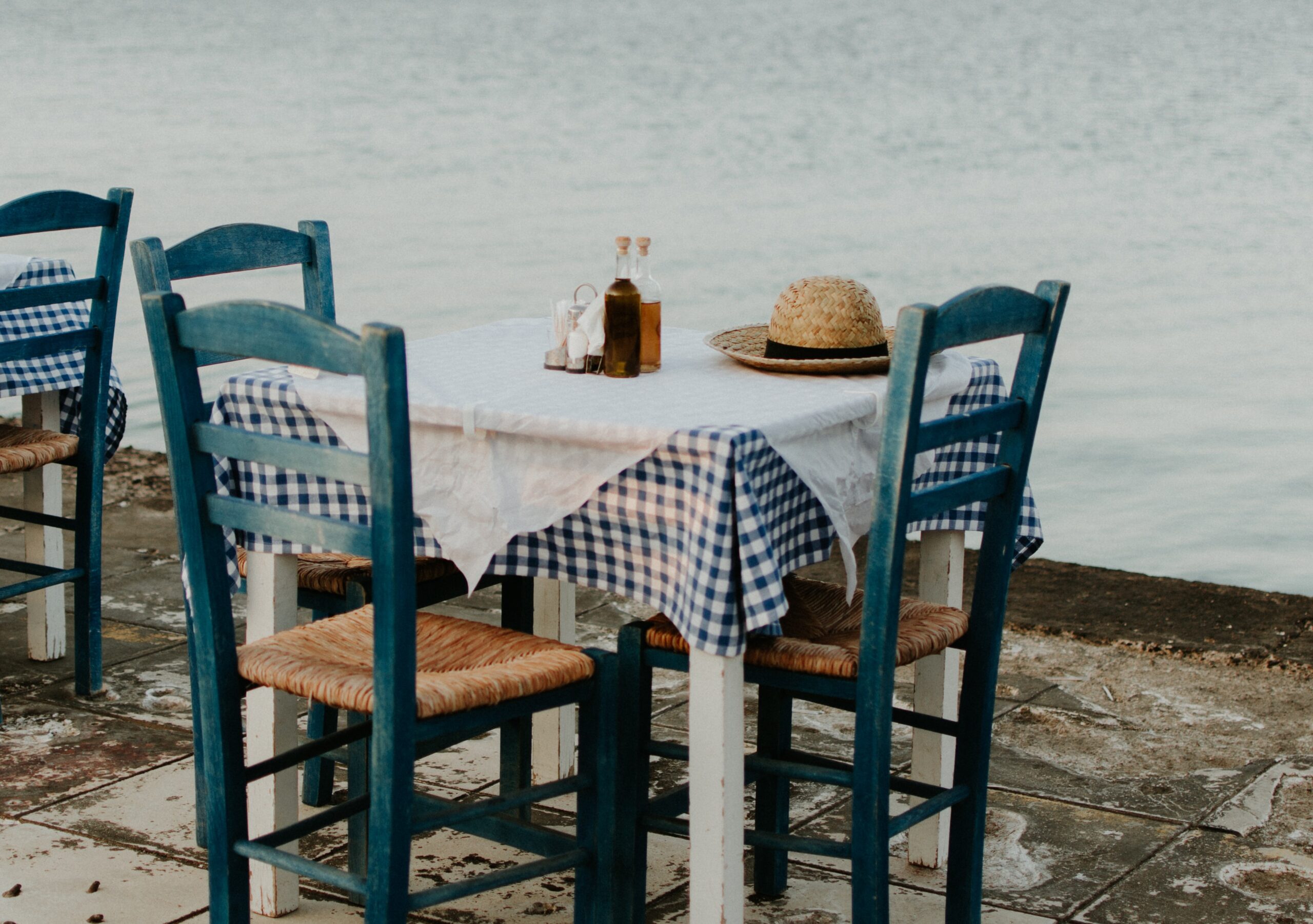 a table and chairs of a restaurant by the sea
