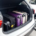 a car boot filled with suitcases