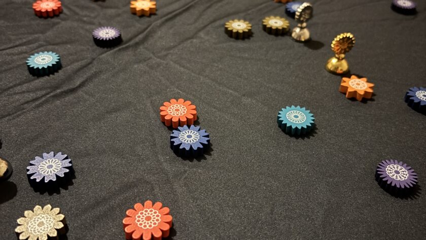 Pieces from Lacuna the game are scattered on the game play mat.