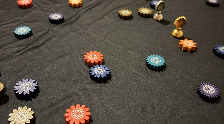 Pieces from Lacuna the game are scattered on the game play mat.
