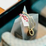 a silver gift bag with a hand written label