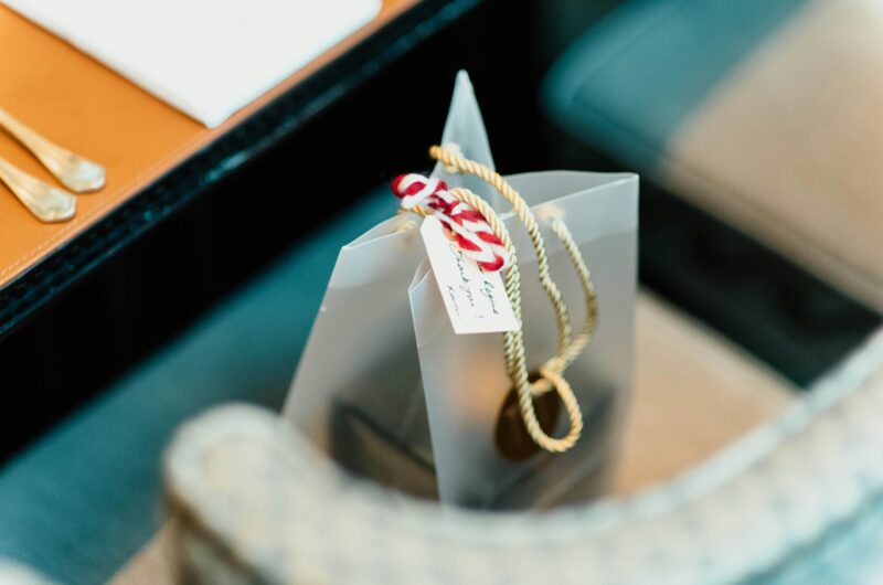 a silver gift bag with a hand written label