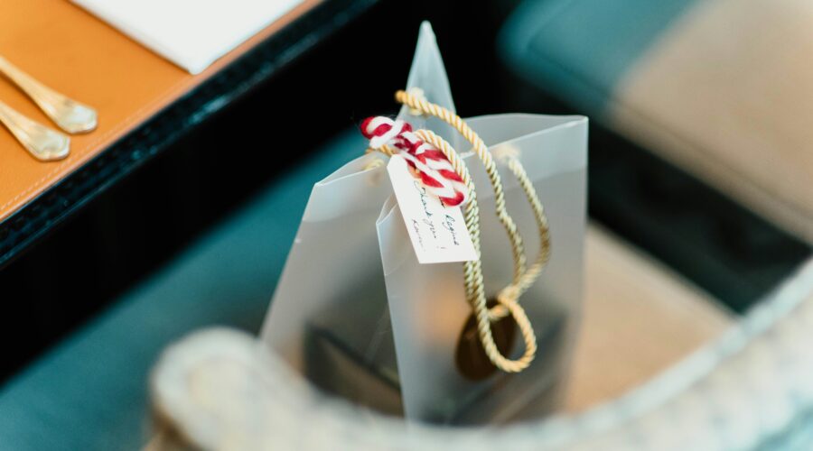 a silver gift bag with a hand written label