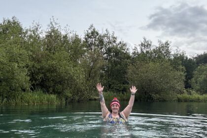 Alex swimming in a blue lake