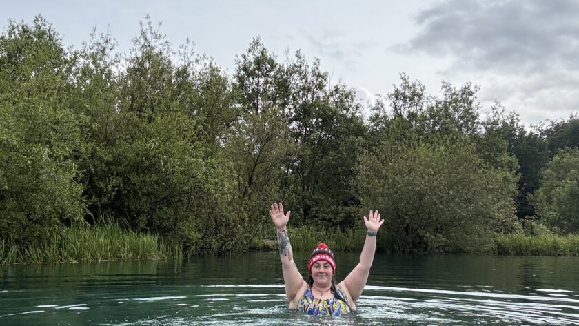 Alex swimming in a blue lake
