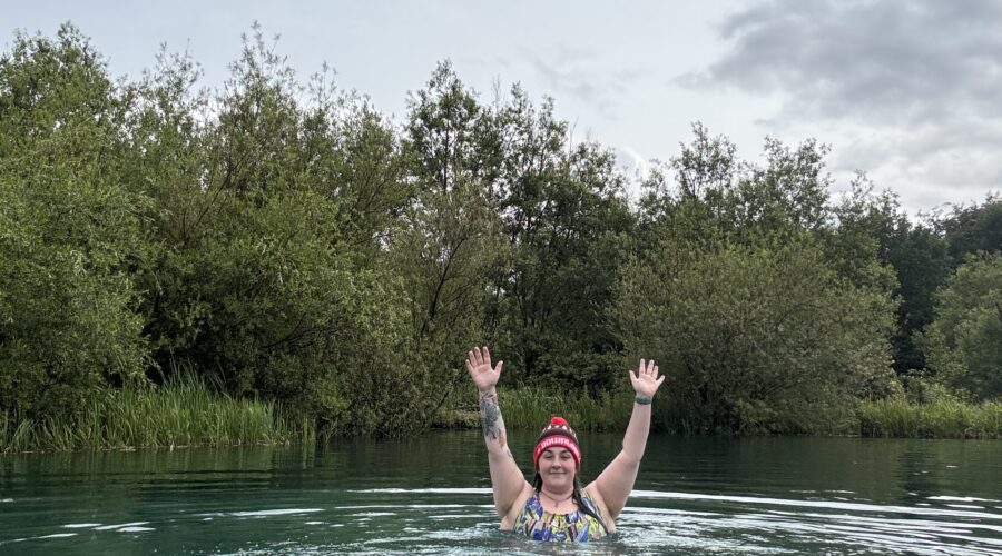 Alex swimming in a blue lake