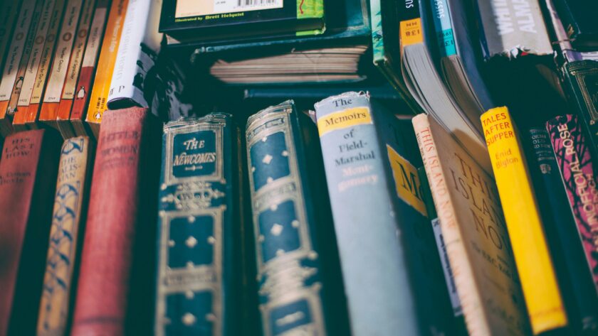 a pile of old classic books